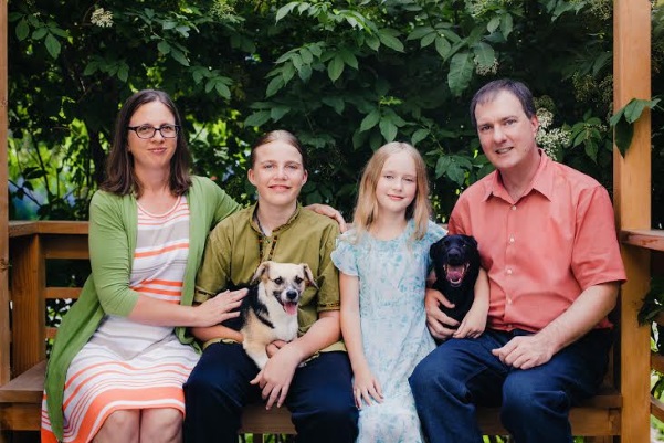 Council candidate Aaron Brockett poses for a family photo. He and his wife started their own business so they could have a more flexible family life. Pictured in this photo is Cherry, Jasper (with dog, Curry), Eliza (with dog Pepper) and Aaron. (photo courtesy Aaron Brockett)